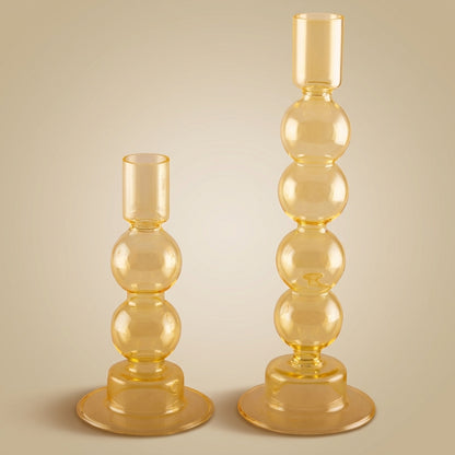 Aulica Bubble Kerzenhalter Gelb im 2er-Set, kleine Variante mit 2 Kugeln (15,5 cm) und große Variante mit 3 Kugeln (23,5 cm), transparentes Bernsteinglas auf neutralem beigen Hintergrund