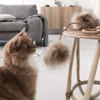 Katze spielt mit hochwertigem Katzenspielzeug Tollo aus Kunstfell, Holz und Leder